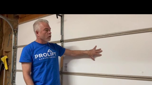 man against garage doors