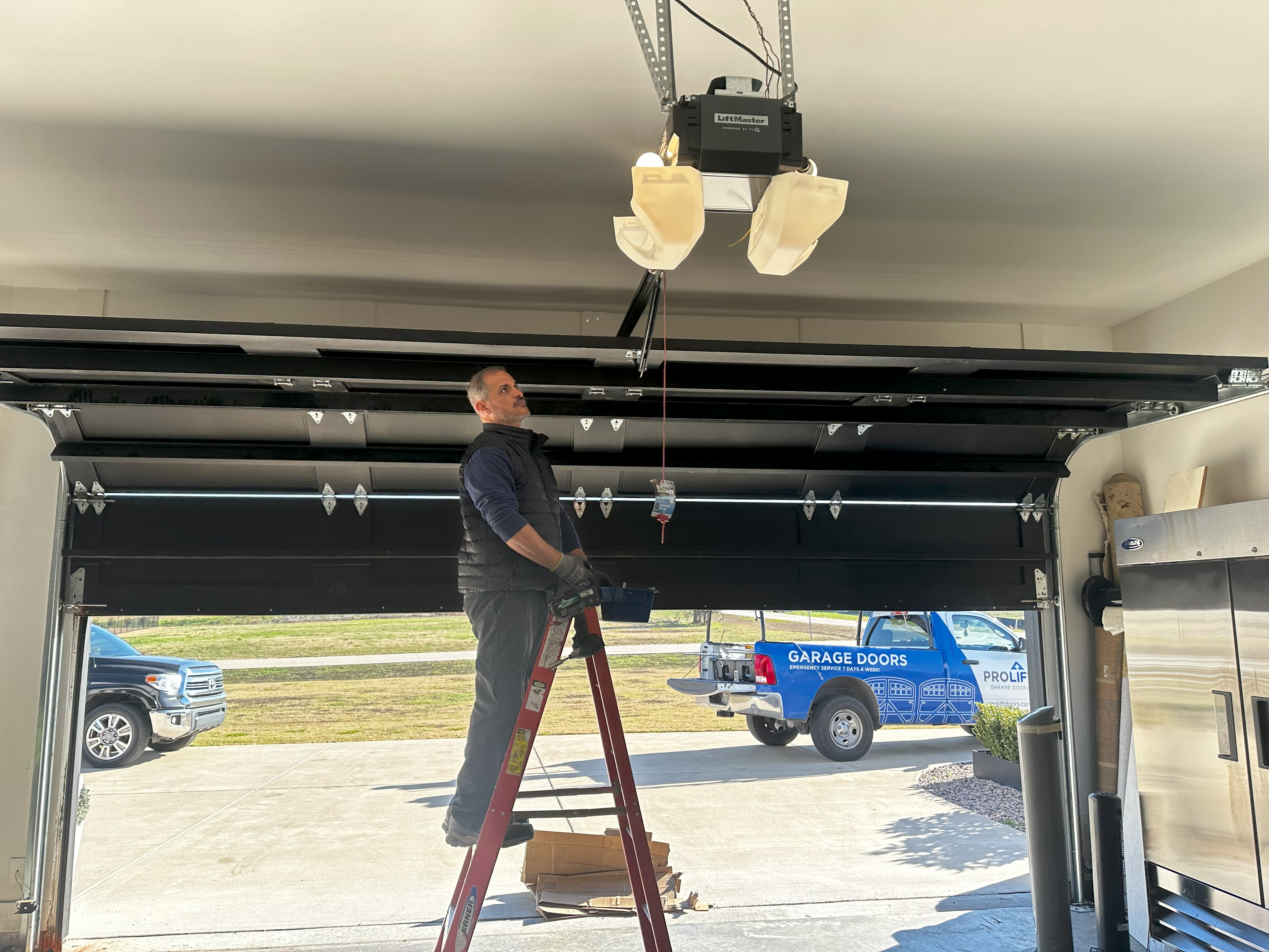 a man adjusting a garage door